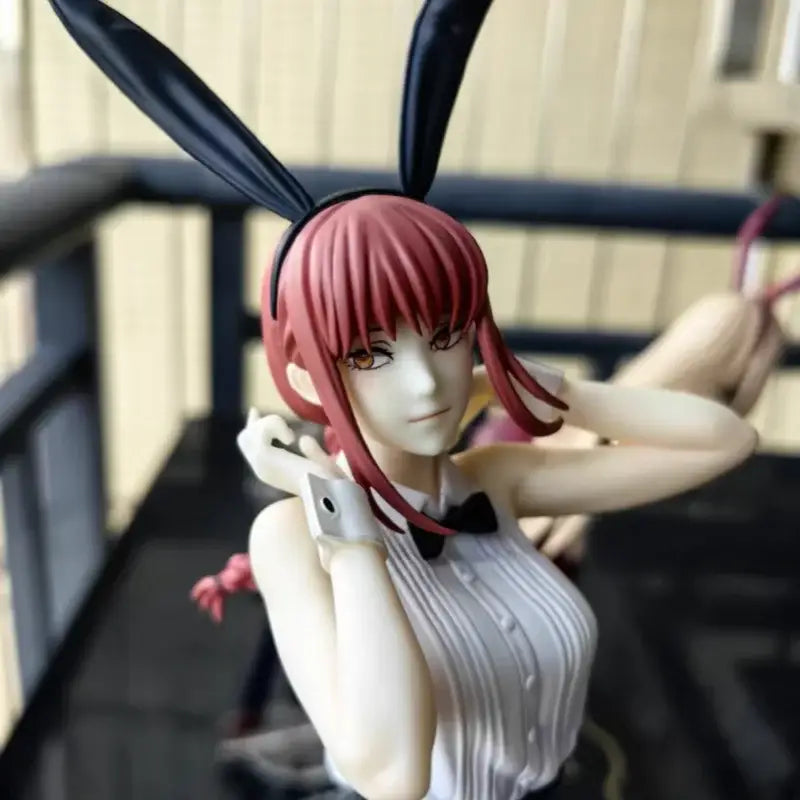 A chainsaw man makima bunny figure pvc collectible with vibrant red hair black bunny ears and a white striped blouse
