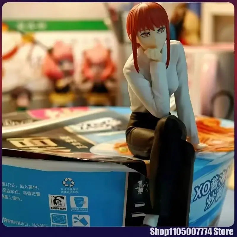 A detailed chainsaw man noodle stopper figure of makima with red hair sitting on a box in pvc material
