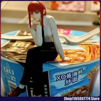 Chainsaw man makima noodle stopper figure with red hair in white blouse and black skirt sitting on blue instant noodle cup