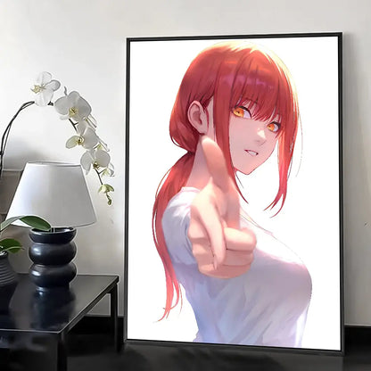 A framed chainsaw man wall poster featuring a red-haired girl with orange eyes in a white top pointing forward