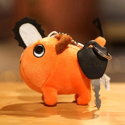 Orange plush pendant shaped like chainsaw with black and white accents soft stuffed pillow from chainsaw man pochita