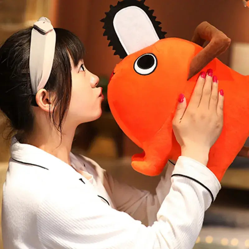 Orange soft stuffed plush pendant shaped like a chainsaw with black and white blade detail from chainsaw man pochita