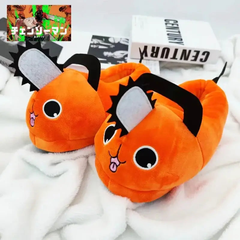 Orange soft plush slippers shaped like chainsaw with black handles silver blades and cute pochita plush eyes and tongues