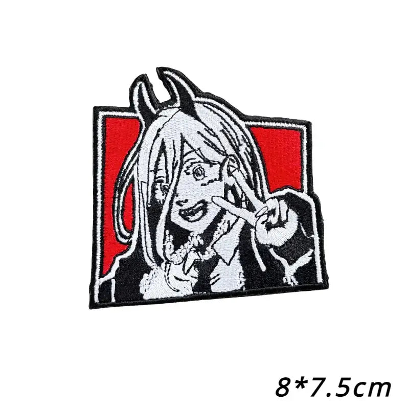 Chainsaw man power embroidered patch in black and white with loop backing features anime character making peace sign on red background