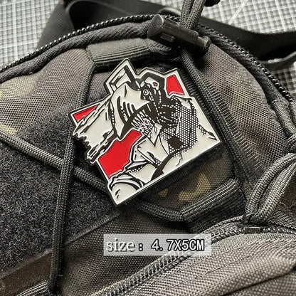 Black white and red enamel pin of a stylized figure in tactical gear with loop backing embroidered patch design