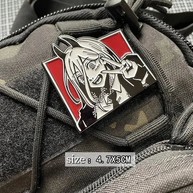 A red and silver enamel pin of an anime character with horns featuring detailed black linework and a glossy finish