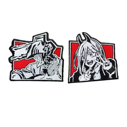 Two embroidered patches featuring chainsaw man characters with loop backing and bold red accents for easy attachment