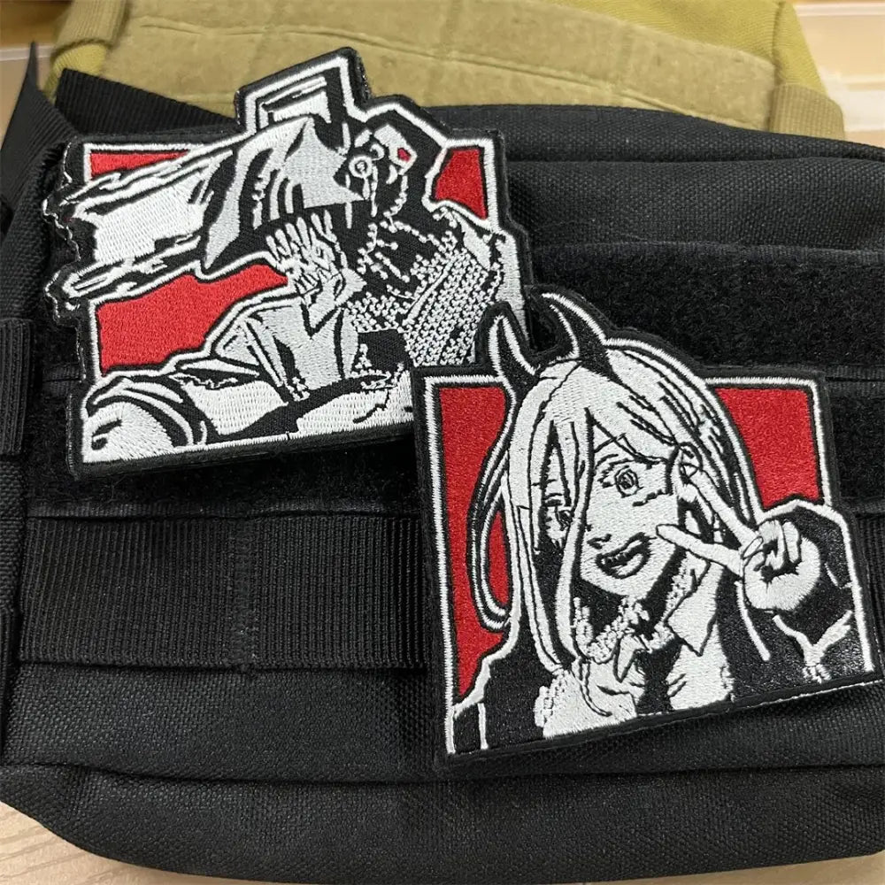 Two embroidered patches with loop backing featuring chainsaw man anime characters on red tactical backgrounds
