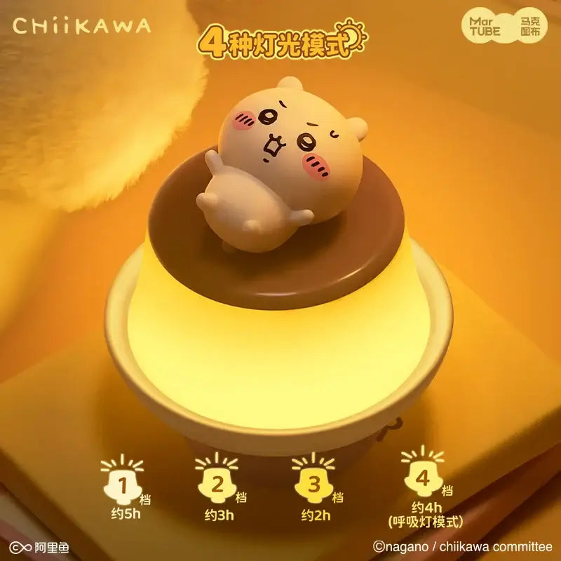 Cute cream-colored chiikawa character figurine perched on warm yellow pudding lamp base for ambient light