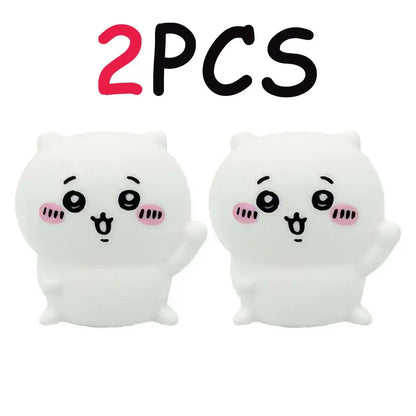 Two white plush chiikawa cartoon cat-shaped vinyl doll stress relievers with pink cheeks for night light use