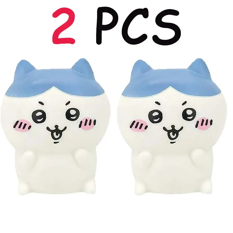 Two white and blue squishy chiikawa hachiware usagi vinyl doll cat figurines with night light feature and pink cheeks