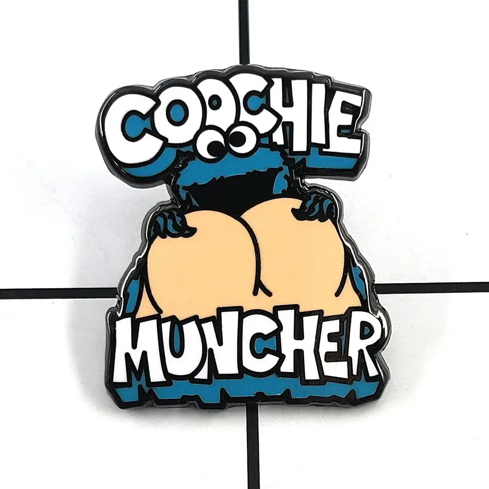Blue and white cookie monster enamel pin cartoon brooch featuring cookie monster holding two buttocks with coochie muncher text