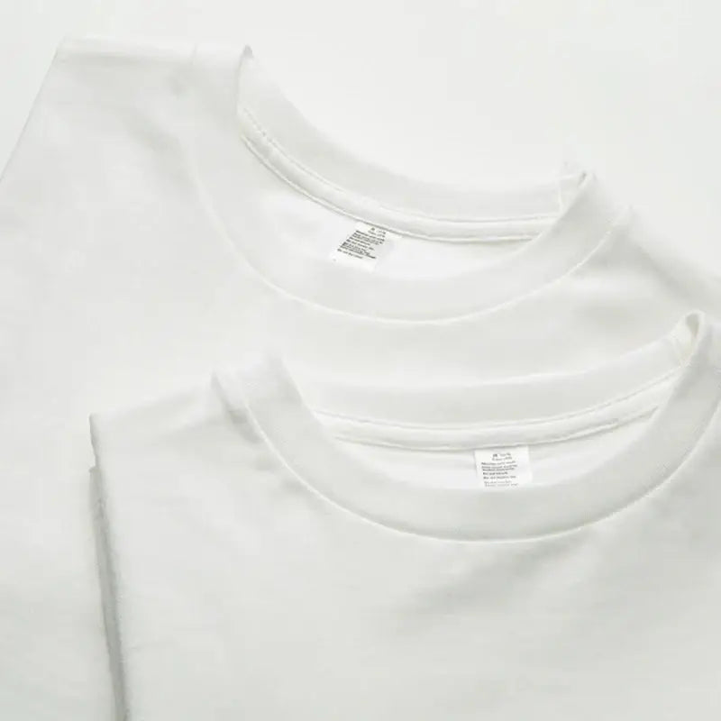 Three crisp white cotton short sleeve t-shirts with clean round necklines ideal for daily wear custom graphic tee