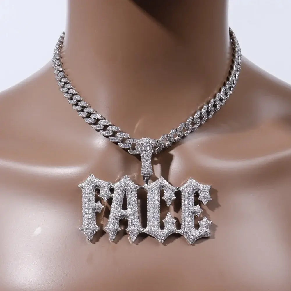 A custom silver letter pendant necklace with a diamond-encrusted faice pendant on a stone spiked rope chain