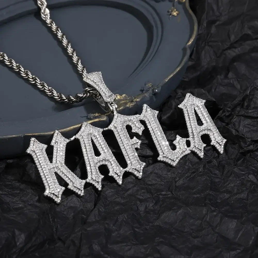 A sparkling silver stone spiked letter pendant necklace with gothic font and clear cubic zirconia stones on rope chain