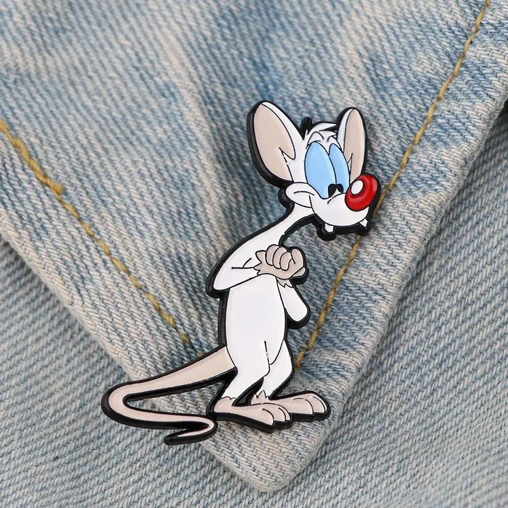 Cute mouse enamel pin featuring white and pink colors with blue eyes red nose black outlines and enamel finish