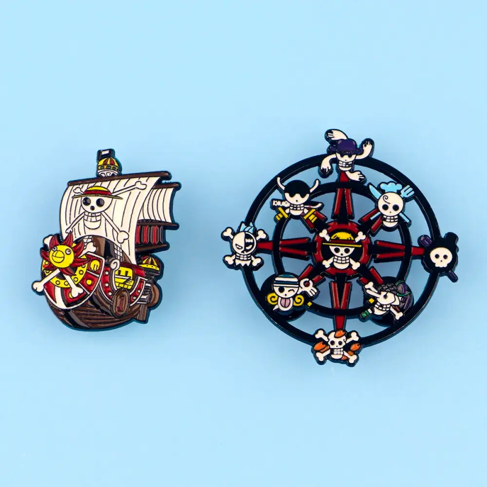 Two colorful enamel pins featuring a pirate ship and skull crew compass rose in a cute ship enamel pin set