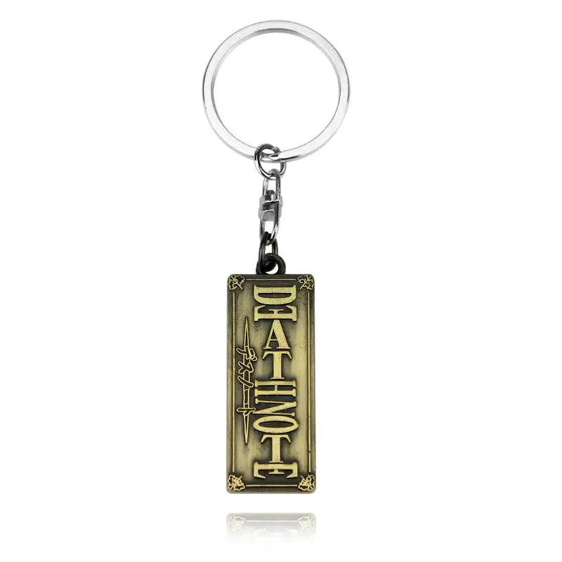Antique brass-colored rectangular keychain with raised deathnote lettering and halberd pendant design for misa amane cosplay