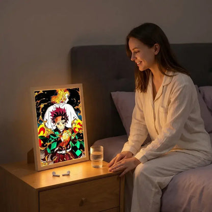 A framed led photo frame of demon slayer kyojuro rengoku with vibrant colors and intricate illuminated details