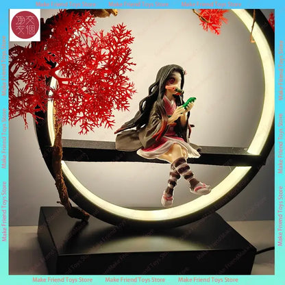 Demon slayer nezuko 3d led night light featuring a detailed figurine in pink and brown seated on a black bench