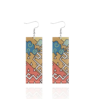 Demon slayer tanjiro butterfly drop acrylic earrings with colorful blue elephant geometric design on tan background