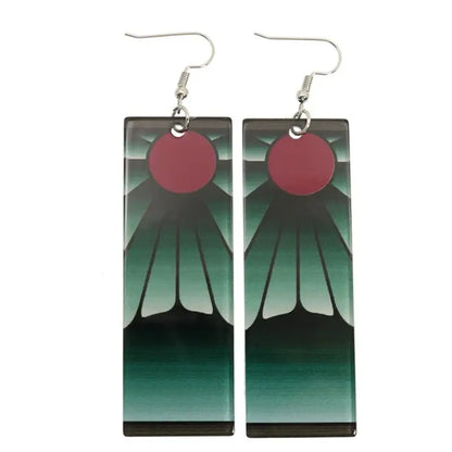Demon slayer tanjiro long drop earrings with red sun acrylic design and silver fishhook clasps against mountain backdrop