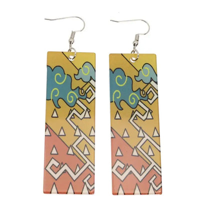 Rectangular demon slayer hanafuda earrings with vibrant teal and yellow acrylic drop design on orange gradient background