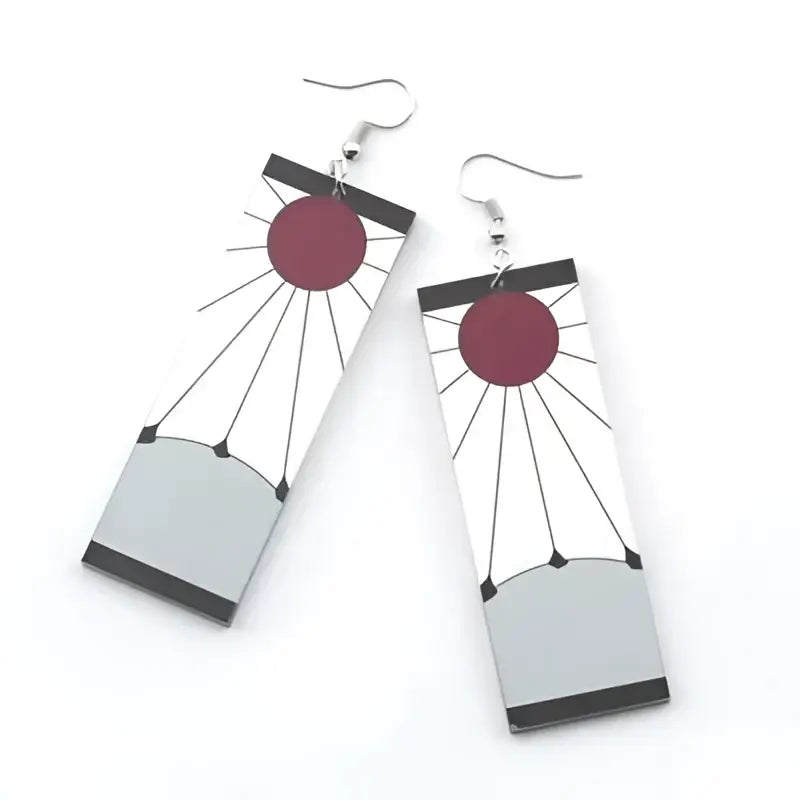 Rectangular demon slayer hanafuda earrings featuring a red circle sun design with black and white acrylic drop patterns