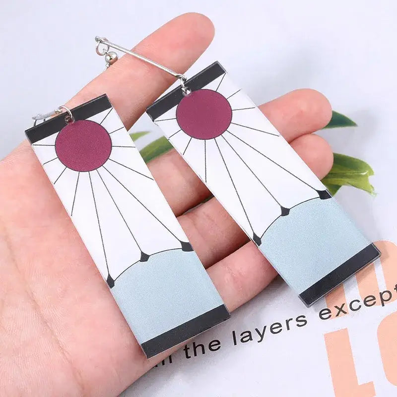 Rectangular acrylic drop hanafuda earrings featuring a stylized sun design with maroon and black on white background for demon slayer fans