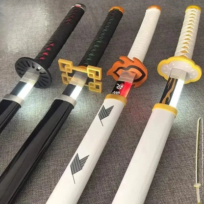 Four illuminated demon slayer led katana swords with black white and orange handles and decorative designs