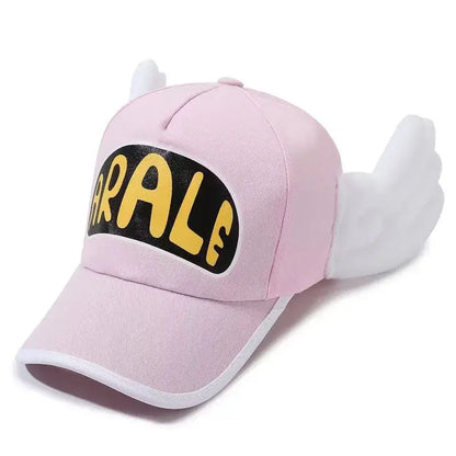 Pink baseball cap with plush wing details and black patch featuring yellow arale lettering dr slump design