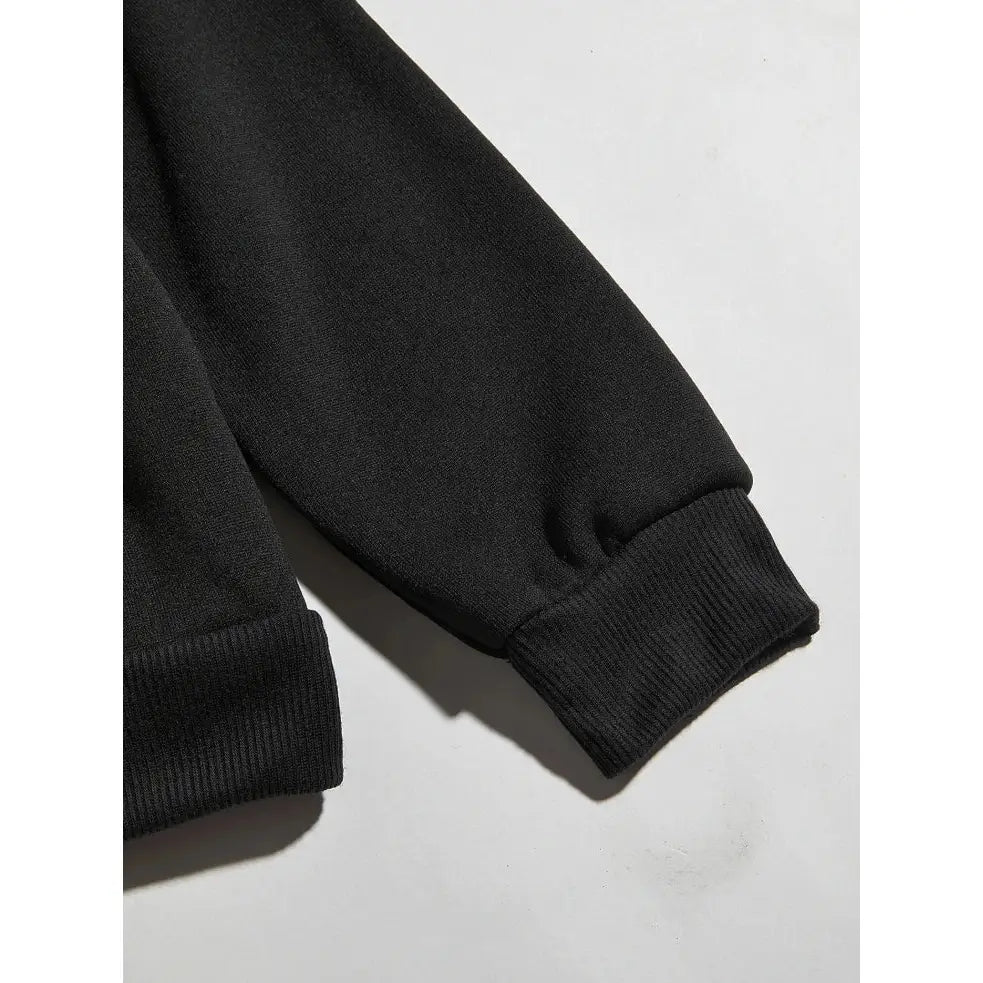 Black ribbed knit cuff on the sleeve of a dragon ball broly oversized hoodie with loose fit design