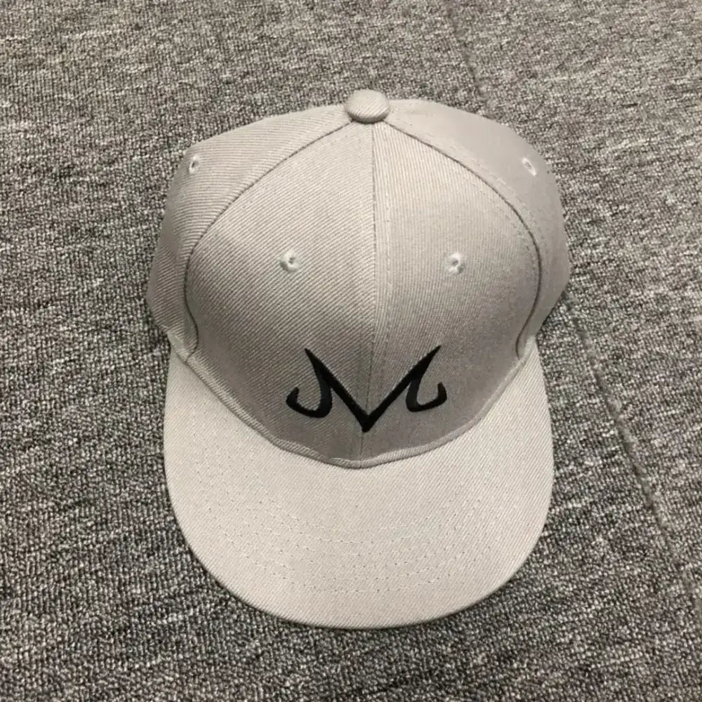 A light gray cotton dragon ball buu snapback cap with a black embroidered m logo for hip hop style