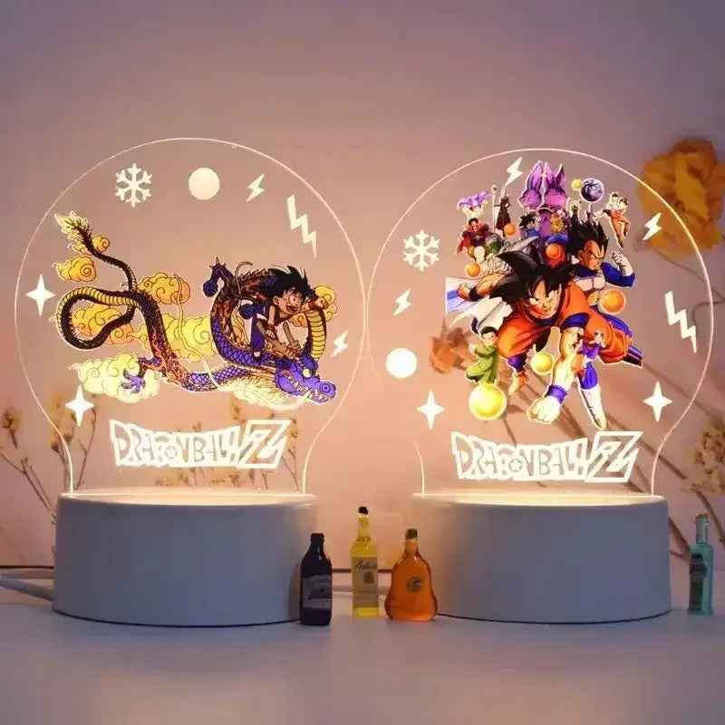 Two illuminated circular dragon ball z led night lights with translucent acrylic bases and glowing character designs for desk lamp decor
