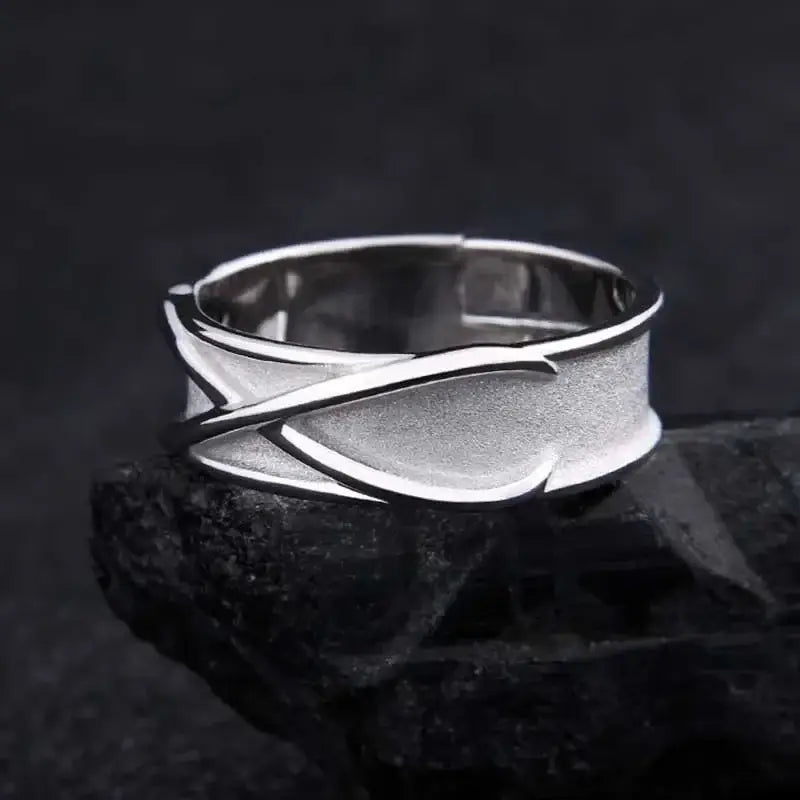 Silver sterling silver goku black ring with modern abstract interwoven bands and textured surface adjustable design