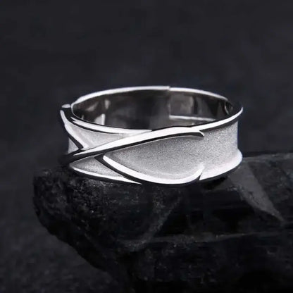 Silver sterling silver goku black ring with modern abstract interwoven bands and textured surface adjustable design