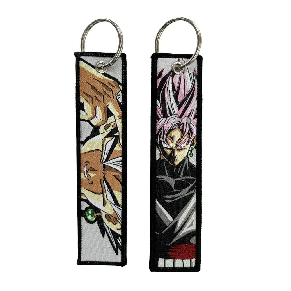 Two embroidered dragon ball goku keychain holders featuring a brown-haired figure and black goku with pink hair