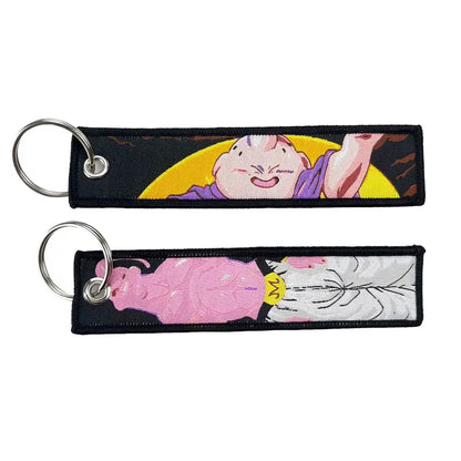 Two embroidered dragon ball keychain holders featuring buu with a yellow moon and pink form in white robes