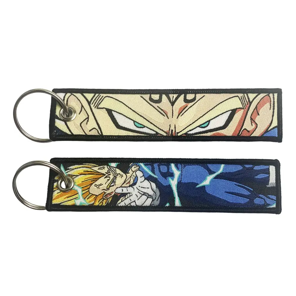 Two embroidered dragon ball keychain holders featuring dragon ball goku in beige blue and yellow hair action design
