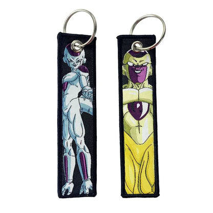 Two embroidered dragon ball goku keychain holders with white purple and yellow purple designs on silver metal rings