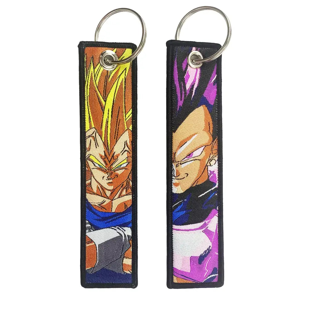 Two embroidered keychain holders featuring dragon ball goku with golden and purple-haired anime characters