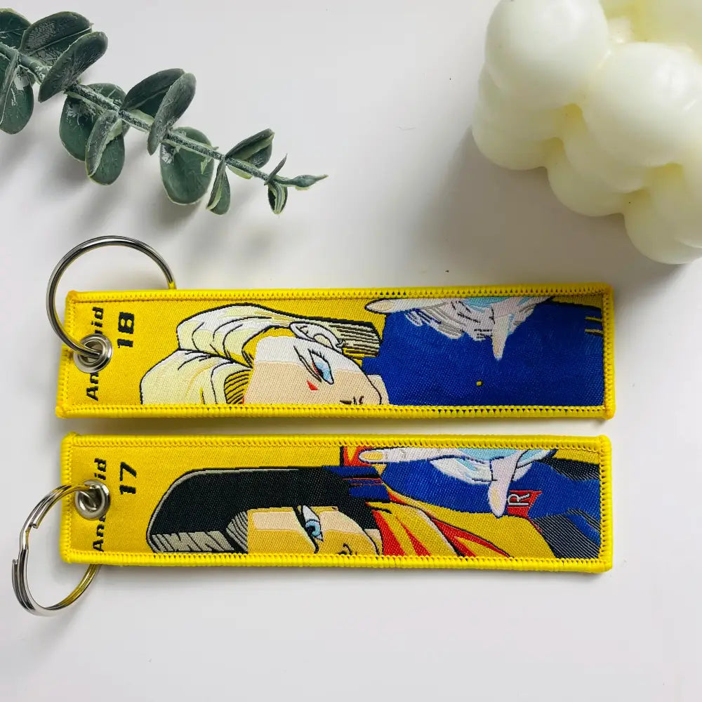 Yellow embroidered dragon ball keychain holder featuring android 17 and 18 with bold blue black and yellow designs