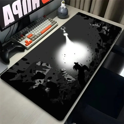 Black and gray rubber desk mat mouse pad featuring an astronaut silhouette illuminated by dramatic spotlight for gaming mouse use