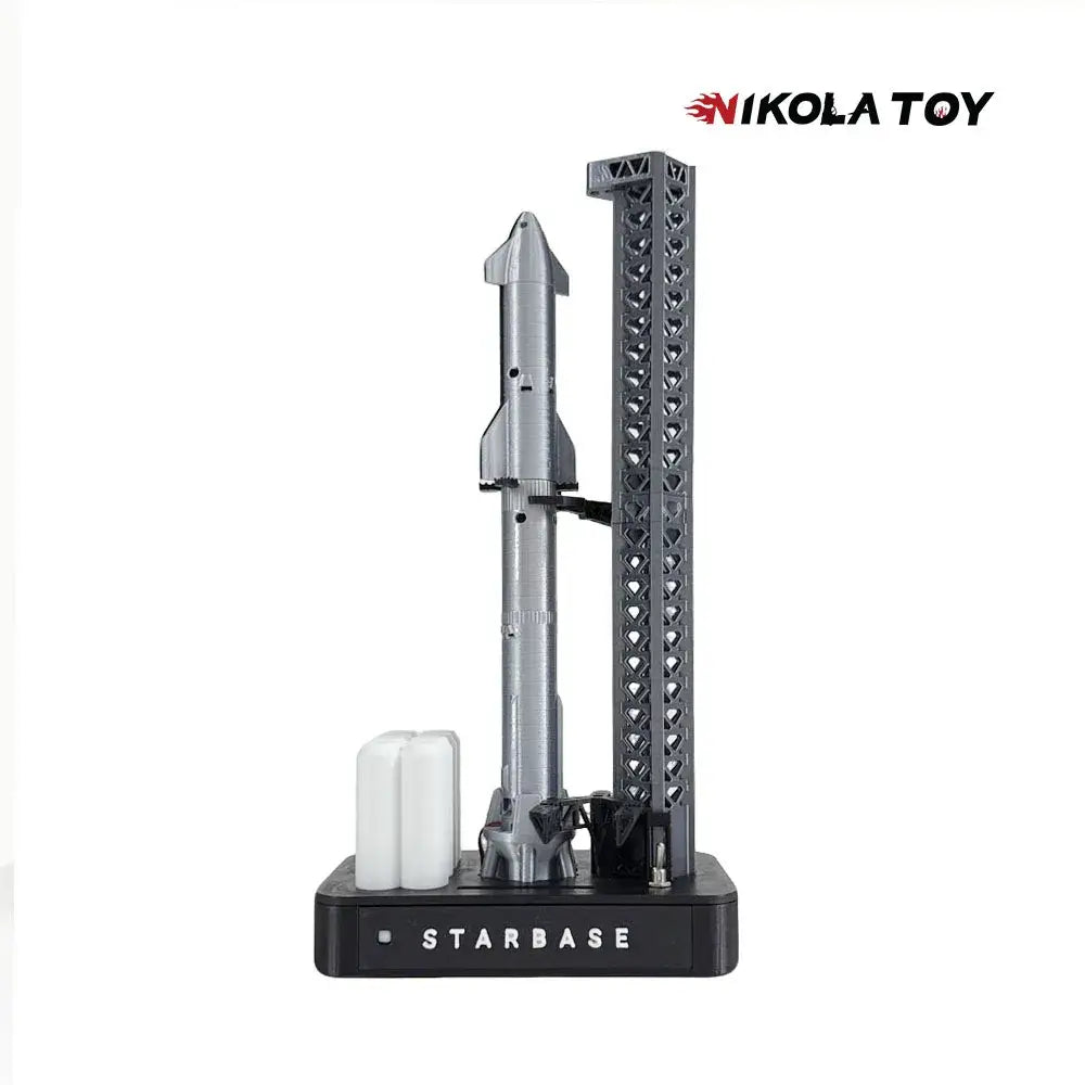 Silver spacex starship rocket model on black starbase display stand with textured support tower magnetic base desk lamp