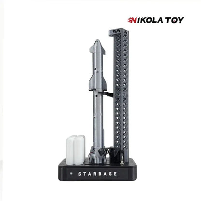 Silver spacex starship rocket model on black starbase display stand with textured support tower magnetic base desk lamp