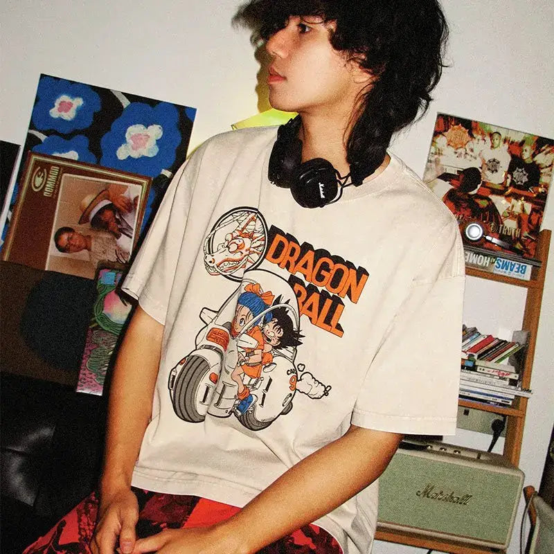 Off-white cotton dragon ball goku oversized t-shirt featuring colorful goku and bulma motorcycle graphic in orange black and gray