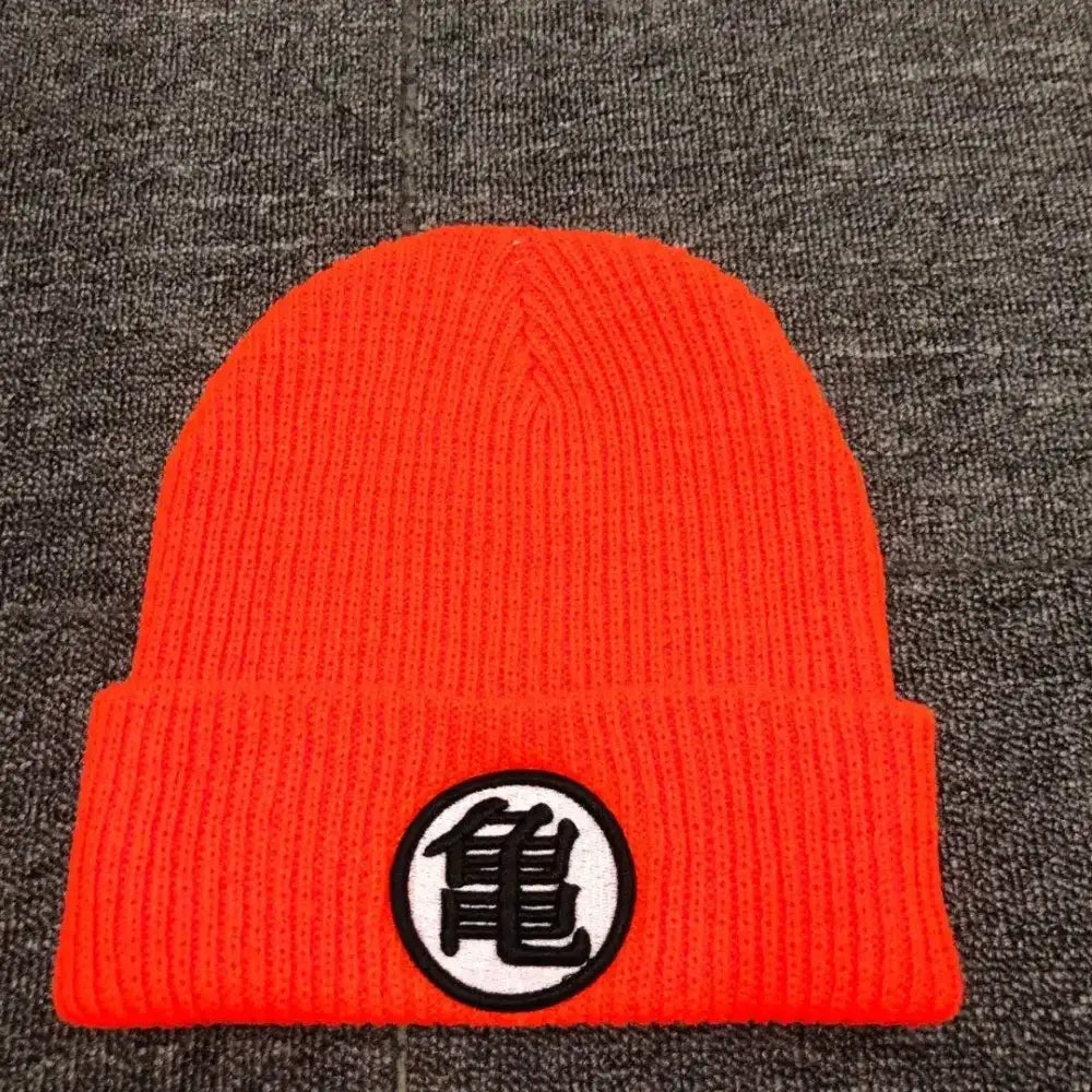Bright orange knitted dragon ball cuffed beanie with circular black kame symbol embroidery on white patch