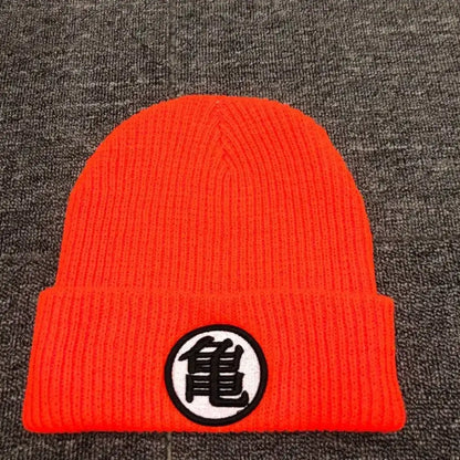 Bright orange knitted dragon ball cuffed beanie with circular black kame symbol embroidery on white patch
