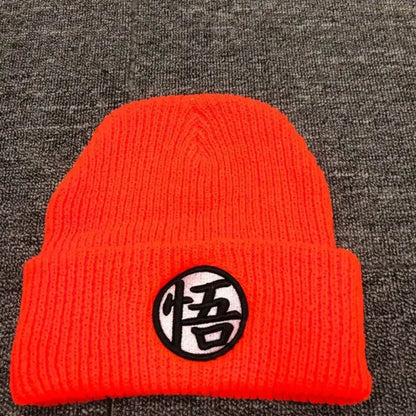 Bright orange knitted cuffed beanie with black and white dragon ball embroidery featuring the悟 character patch