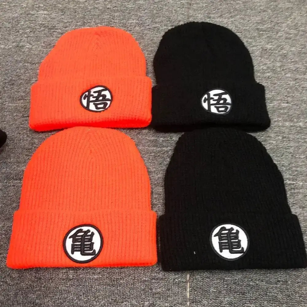 Two knitted cuffed beanies in bright orange and black with dragon ball embroidery featuring japanese characters